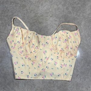 Flower designed shirt that is open in the back.